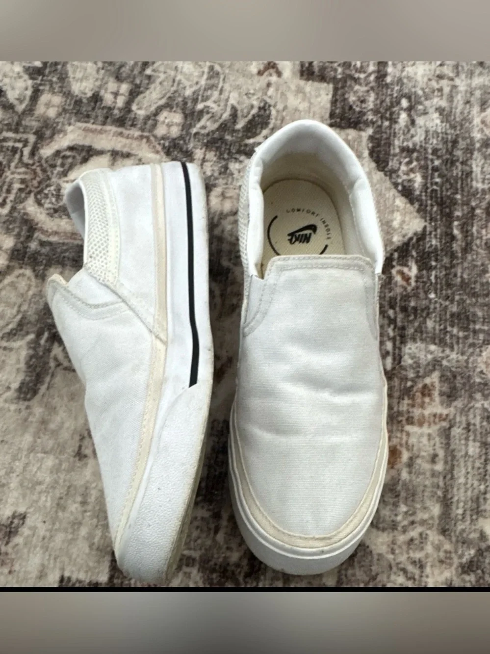 Nike Women’s White Slip-On Sneakers with Black Swoosh Accent
